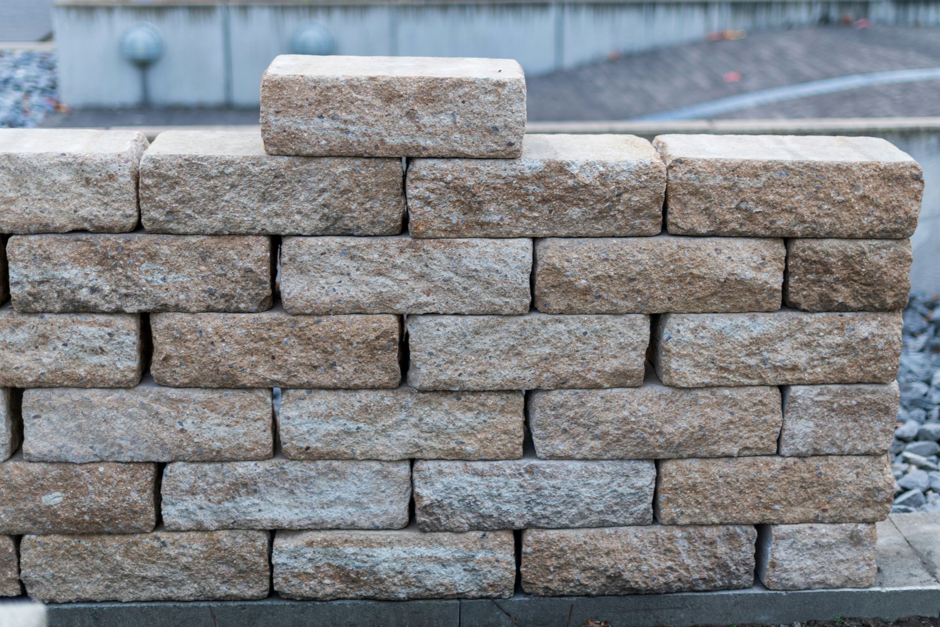 A wall made of rough, tan-colored stones
